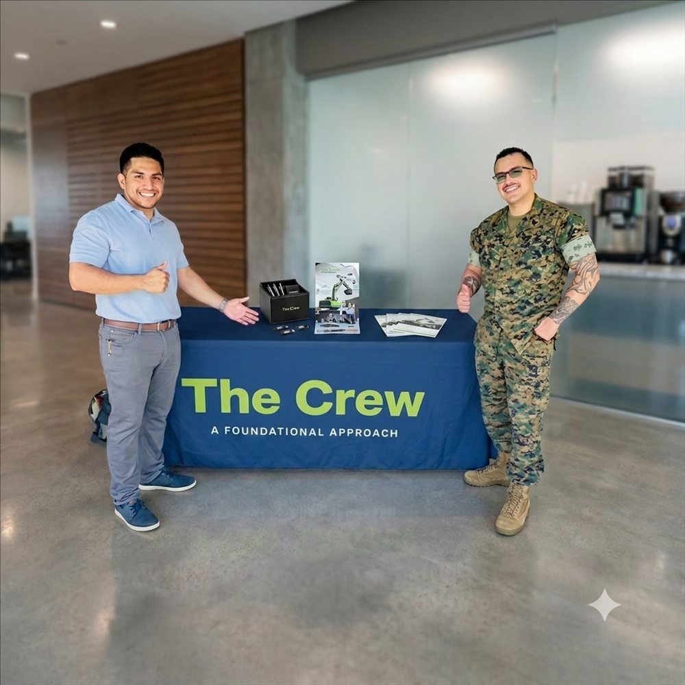 David Contreras standing with a United States Marine at a client event for The Crew Construction.